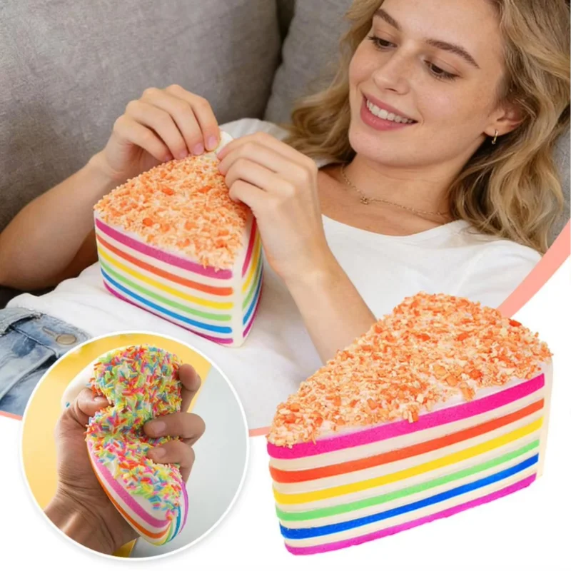 A woman holds a rainbow layer cake squishy toy with colorful frosting and stripes.