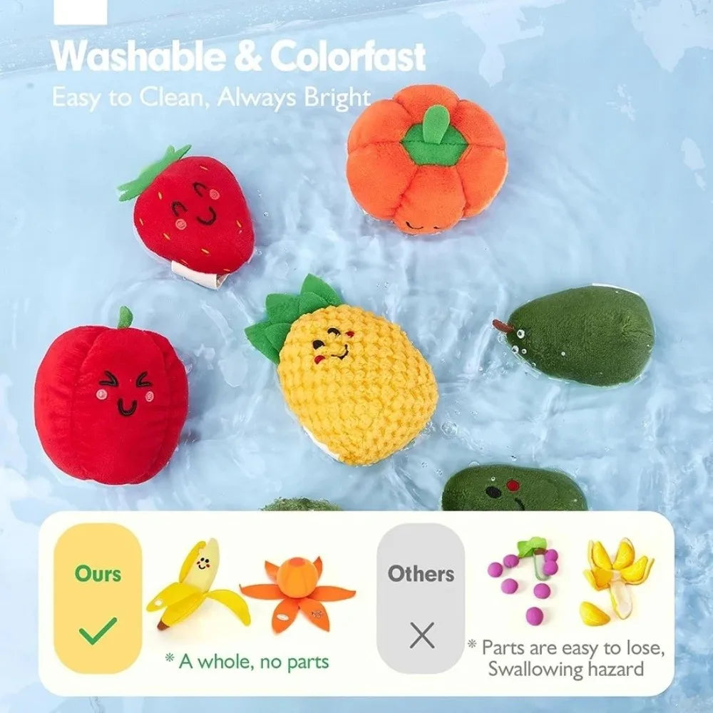 A set of colorful, crinkly fruit and vegetable shapes floating in water for sensory play.