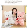 A white and pink plush bear gift set with a red rose design displayed on a wooden table.