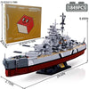 A model kit of the Bismarck Battleship shown in a side view, featuring gray and black components on a black base.