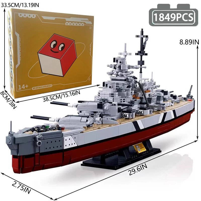 A model kit of the Bismarck Battleship shown in a side view, featuring gray and black components on a black base.