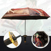 A brown and black 3-fold umbrella is shown with a Demon Slayer katana accessory and a character illustration in the backgroun