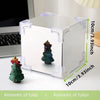 A clear cube craft kit featuring a small Christmas tree decoration used as a night light.
