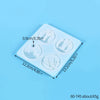 A white silicone mold tray with multiple circular cavities for jewelry and craft projects.