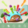 A colorful hedgehog toy with various colored fingers and a round body used for fine motor skills development.
