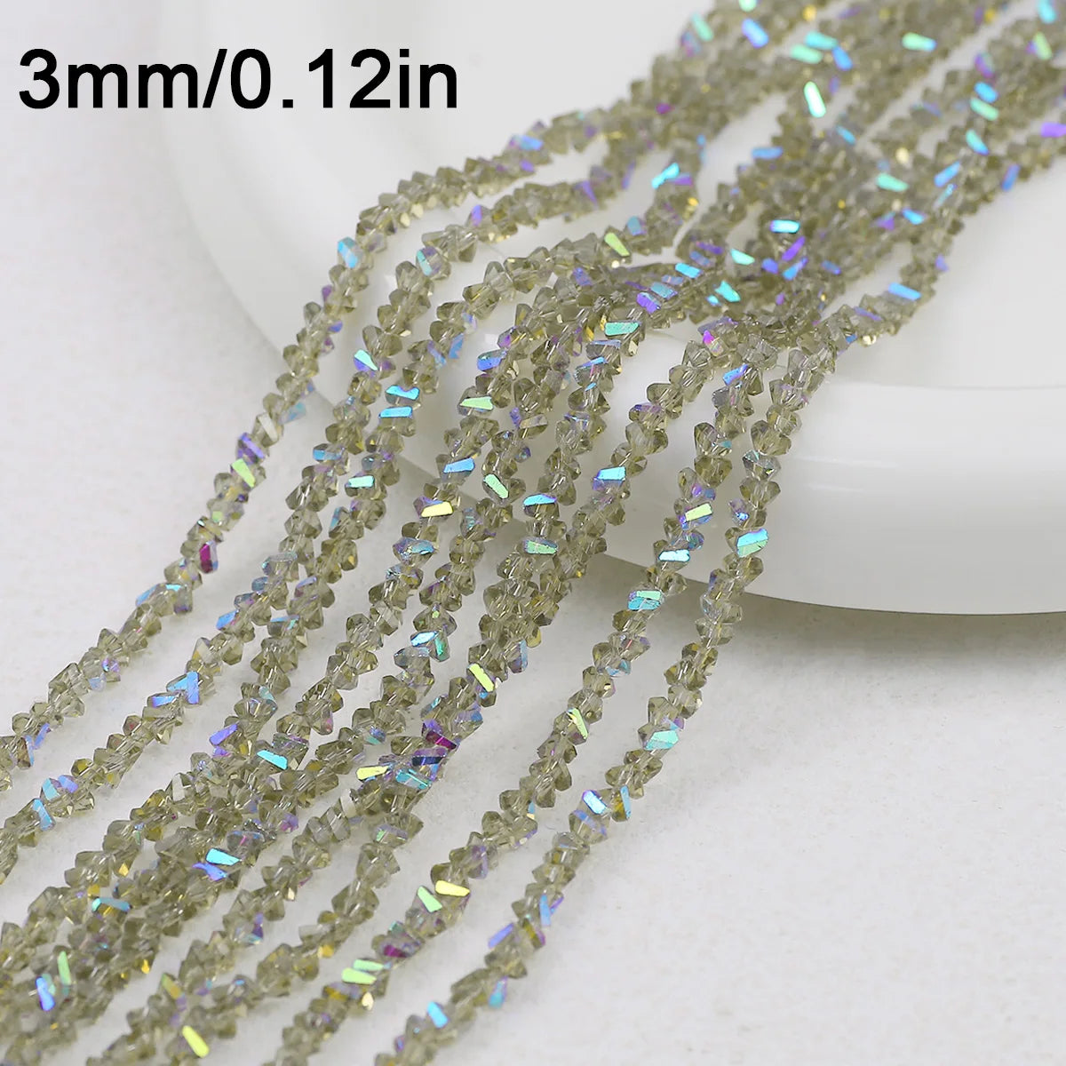 A close-up of multiple strands of clear crystal triangle beads for jewelry making