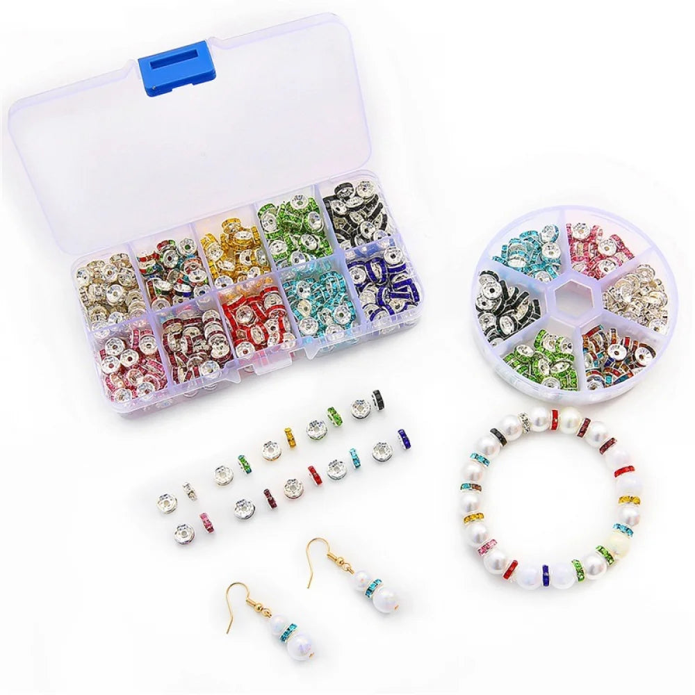 A clear plastic box containing various colored crystal rondelle spacer beads and a string of beaded jewelry.