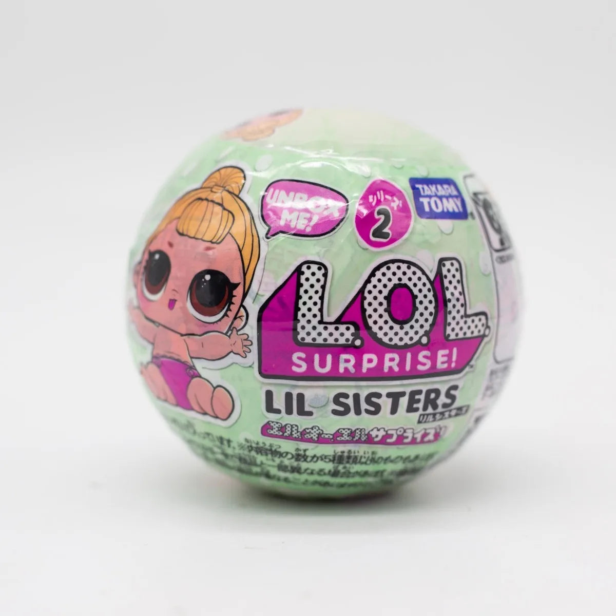 A green blind ball from the LOL Surprise! Lil Sisters Series 2 featuring a character and surprise elements.