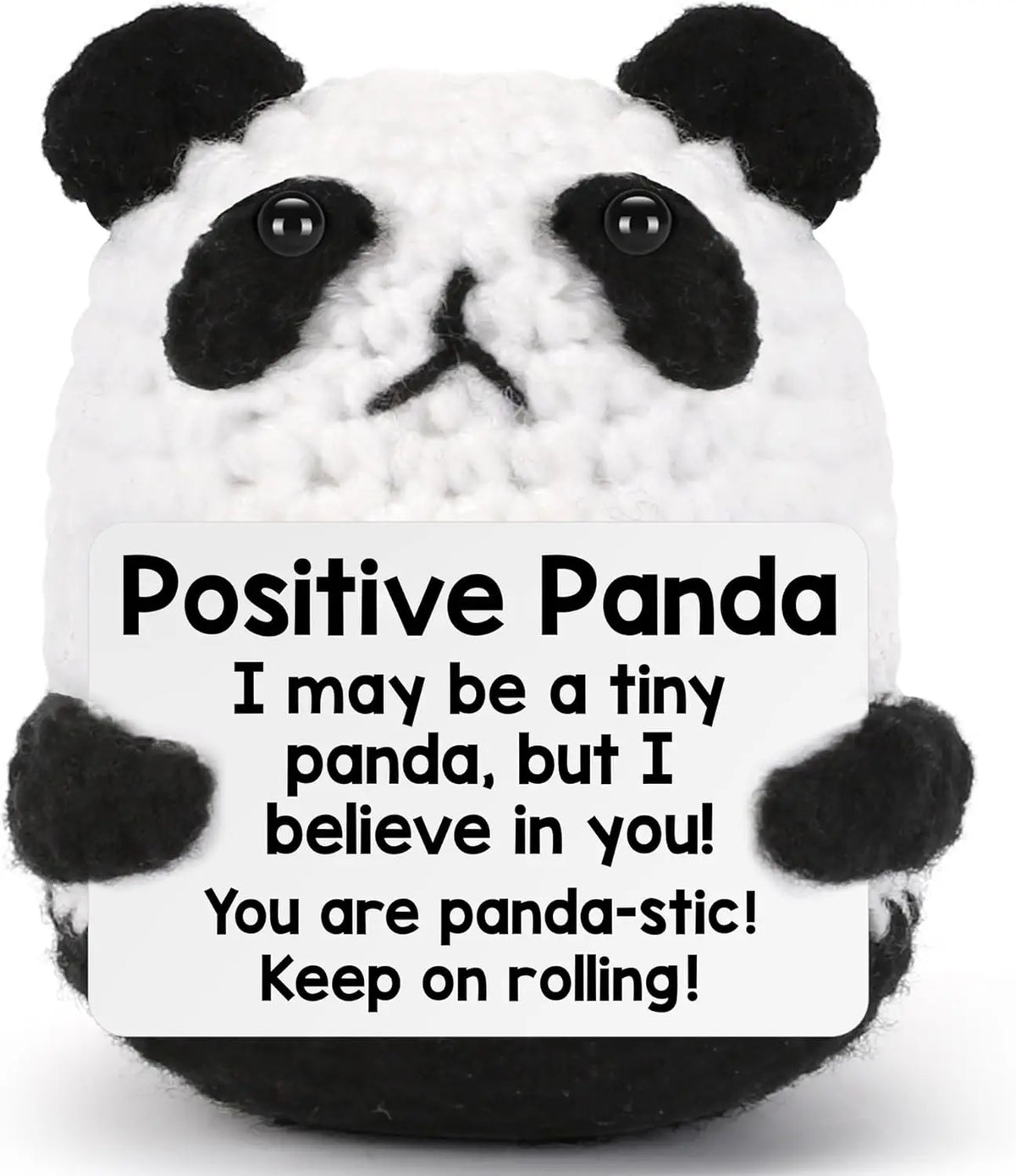 A white and black crocheted panda plush toy with a positive message on the tag.