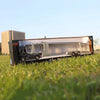 A 1:50 scale diecast alloy container truck with lights and sounds displayed on green grass.