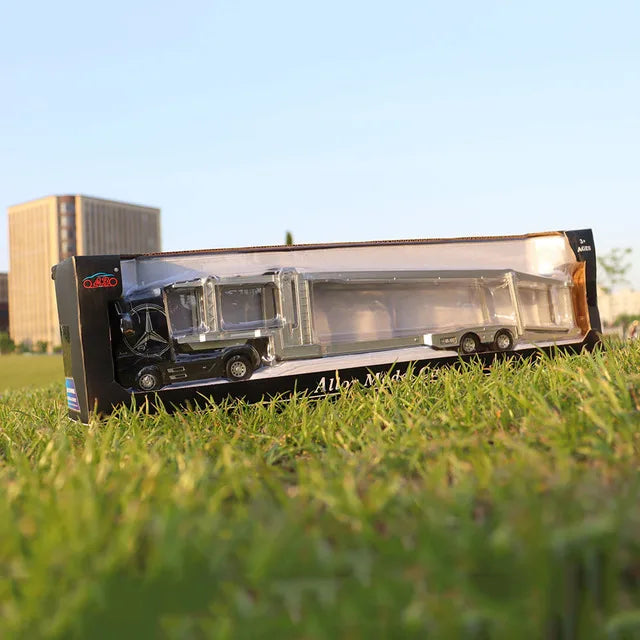 A 1:50 scale diecast alloy container truck with lights and sounds displayed on green grass.