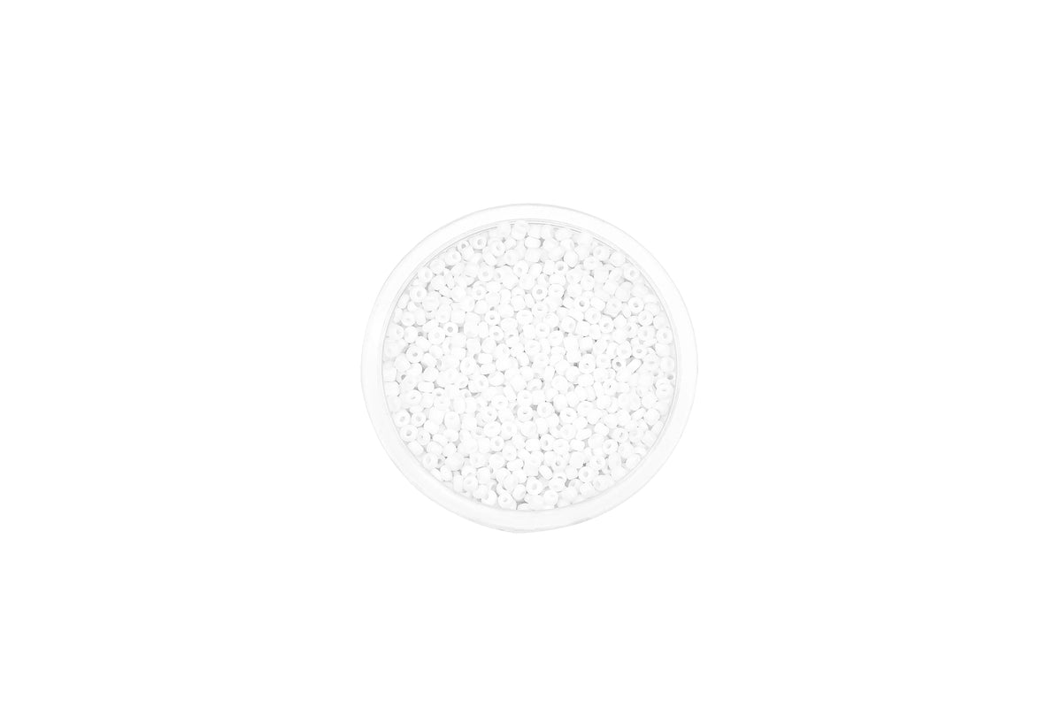 A clear plastic container filled with small, round, white glass seed beads for jewelry making.