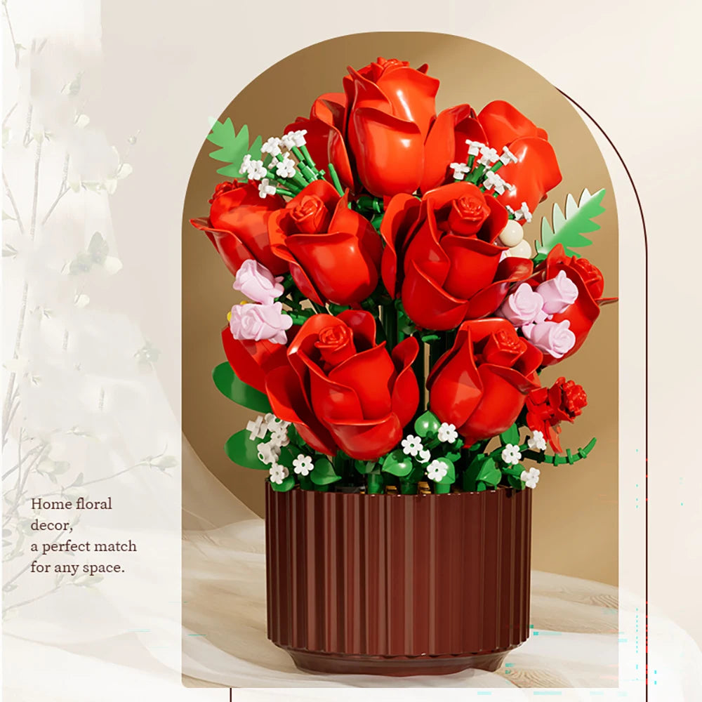 A bouquet of red roses and white filler flowers in a brown planter.