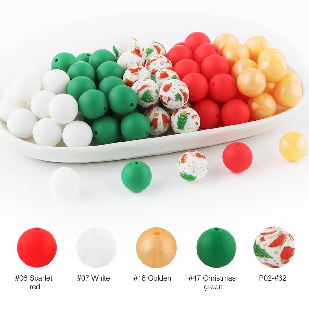 A variety of soft food-grade silicone beads in red, white, green, and gold are displayed in a white dish.