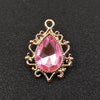 Gold plated water droplet charm featuring a pink crystal rhinestone flower.