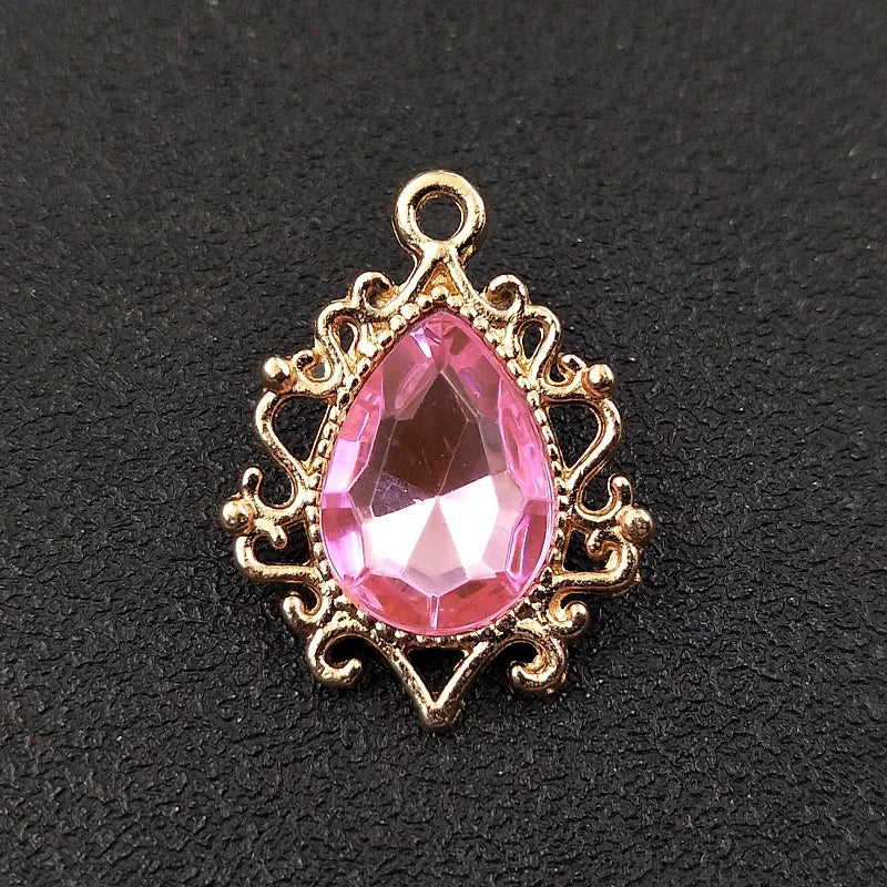 Gold plated water droplet charm featuring a pink crystal rhinestone flower.
