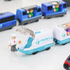 A white and teal battery-powered magnetic wooden train set with a transparent engine piece and a figure on the track.