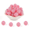 A pile of pink and clear rhinestone resin bayberry beads for jewelry making.