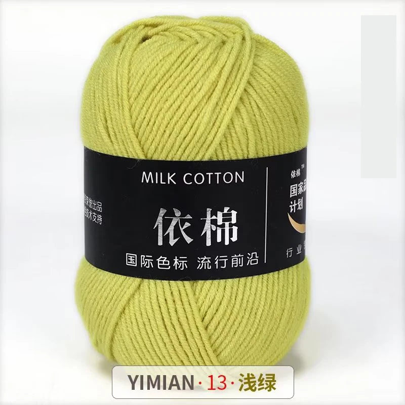 A ball of light yellow milk cotton yarn labeled YIMIAN 13, ready for knitting or crochet.