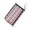 A portable baby changing mat with a storage bag featuring a pattern of pink and gray circles.