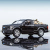 A black Ford F150 SVT Raptor 1:36 diecast model truck parked on a reflective surface.