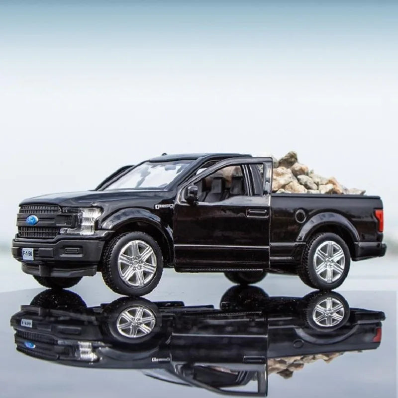 A black Ford F150 SVT Raptor 1:36 diecast model truck parked on a reflective surface.