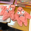 A pair of pink plush hand charms with exaggerated, angry facial expressions.