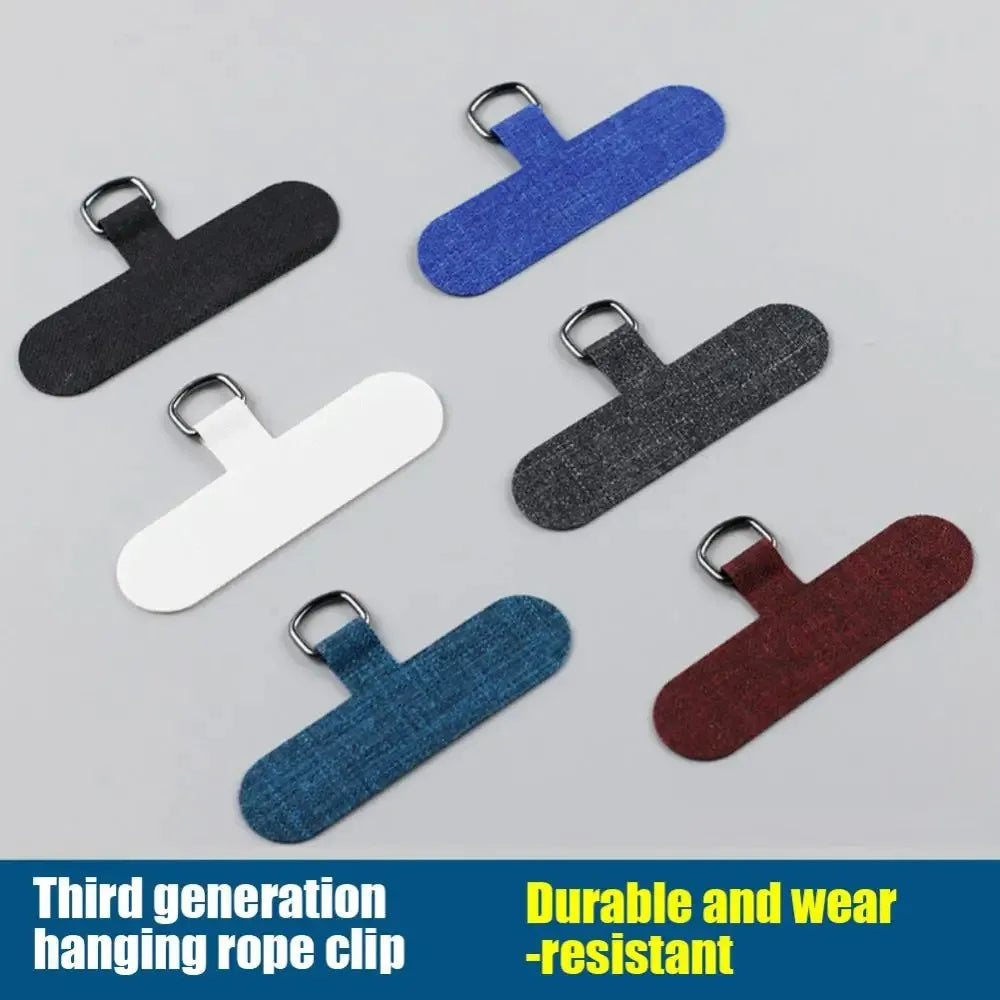 A collection of blue, black, and white durable hanging rope clips or phone lanyards.