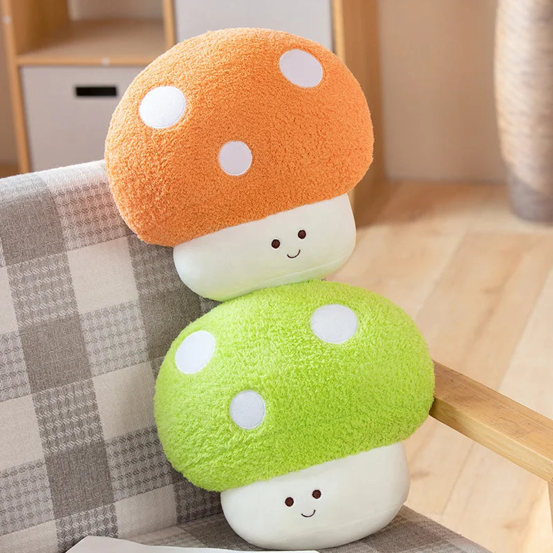 A cute mushroom plush toy with an orange cap and a lime green cap resting on a light-colored surface.