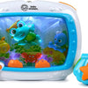 A white ocean-themed crib soother with a clear window showing a blue and green stuffed animal.