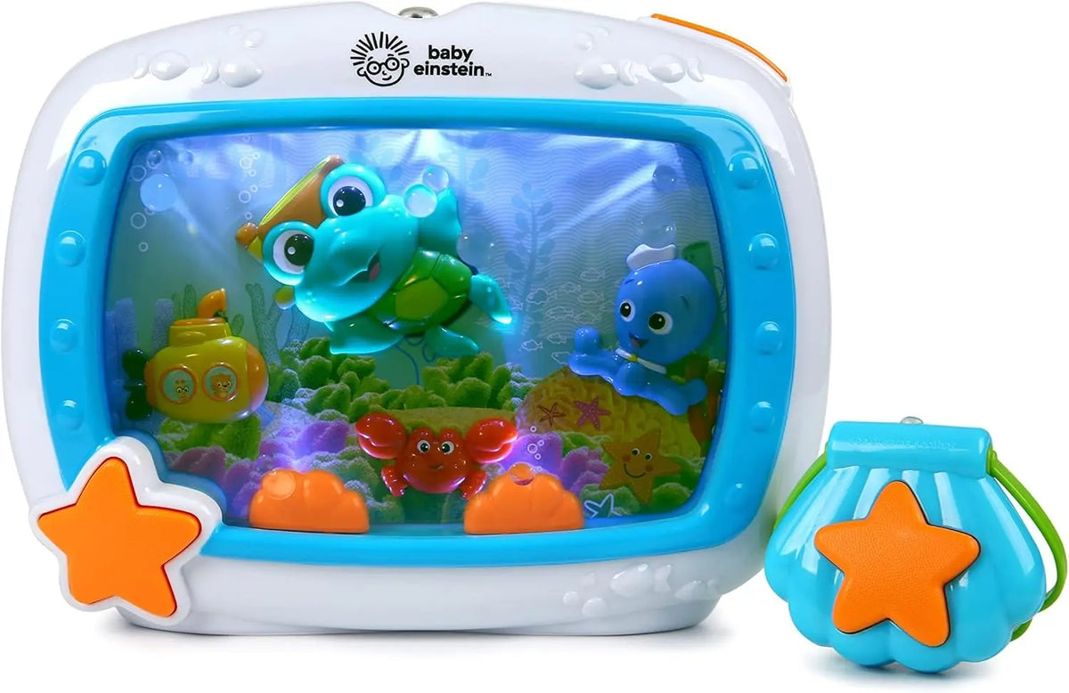 A white ocean-themed crib soother with a clear window showing a blue and green stuffed animal.