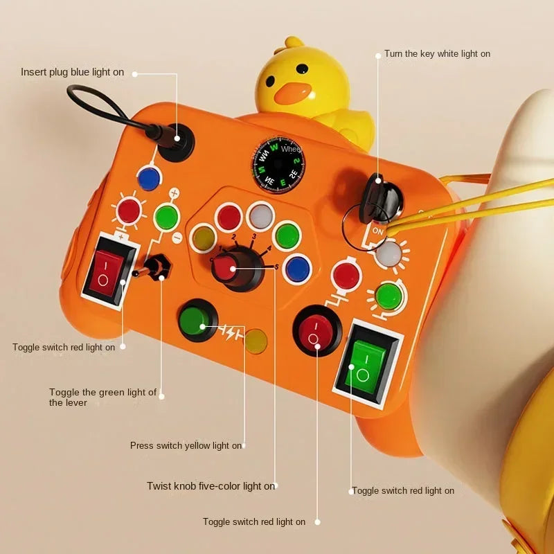An orange Montessori busy board with various LED light switches and levers, shown being operated by a hand.
