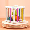 A white Montessori shape sorting cube with colorful elastic bands and wooden blocks on a round base.