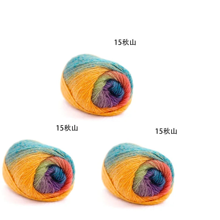 A close-up of a skein of hand-dyed rainbow merino wool yarn showing various shades of orange, yellow, blue, and purple.