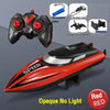 A red speedboat toy with a remote control, charging cable, and propeller display rack.