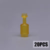 A small, yellow glass bottle with a stopper, part of a building block treasure chest set.