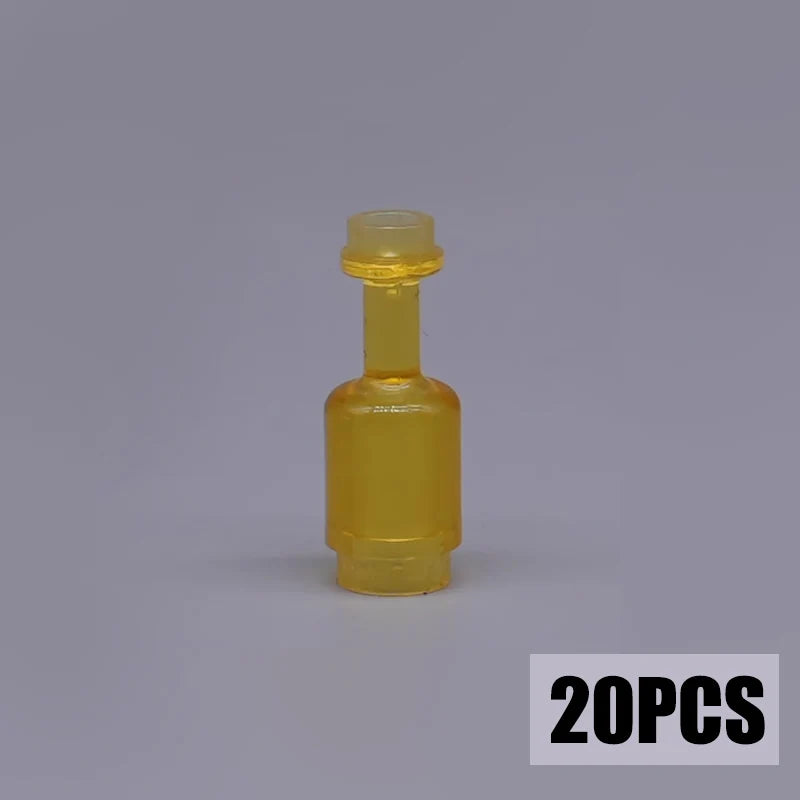 A small, yellow glass bottle with a stopper, part of a building block treasure chest set.