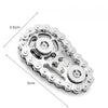 Silver metal fidget spinner desk toy with a decorative edge and a central rotating mechanism.