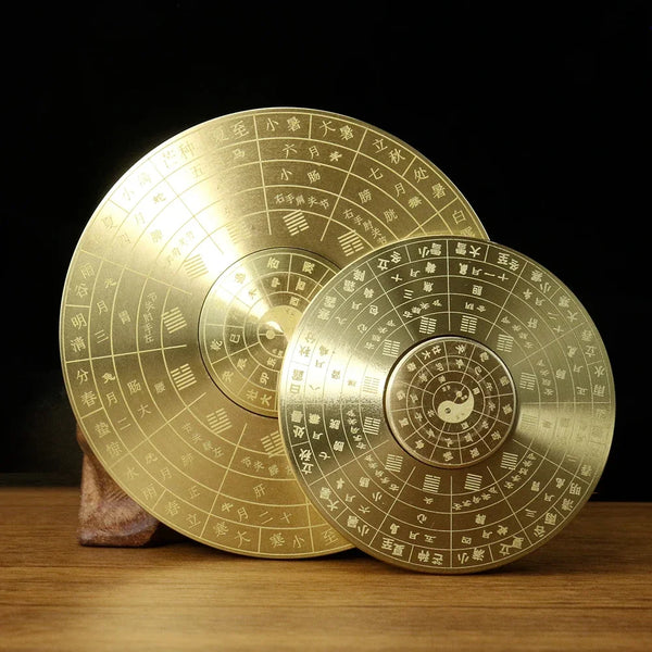 Traditional brass Yin Yang compass decor with intricate markings on a wooden surface.