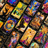 A collection of illuminated tarot cards featuring various mystical figures, symbols, and celestial scenes.