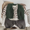 A stack of olive green knitted cardigan and dark gray pants for boys