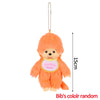 An orange fluffy cartoon plush toy with a yellow collar and a silver chain.