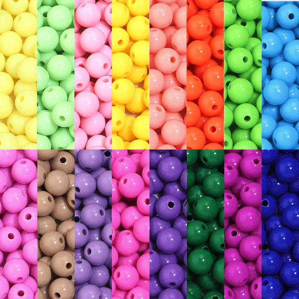 A vibrant assortment of acrylic spacer beads in various colors including yellow, green, pink, orange, and blue.