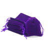 A purple compact drawstring dice bag with multiple strings visible.
