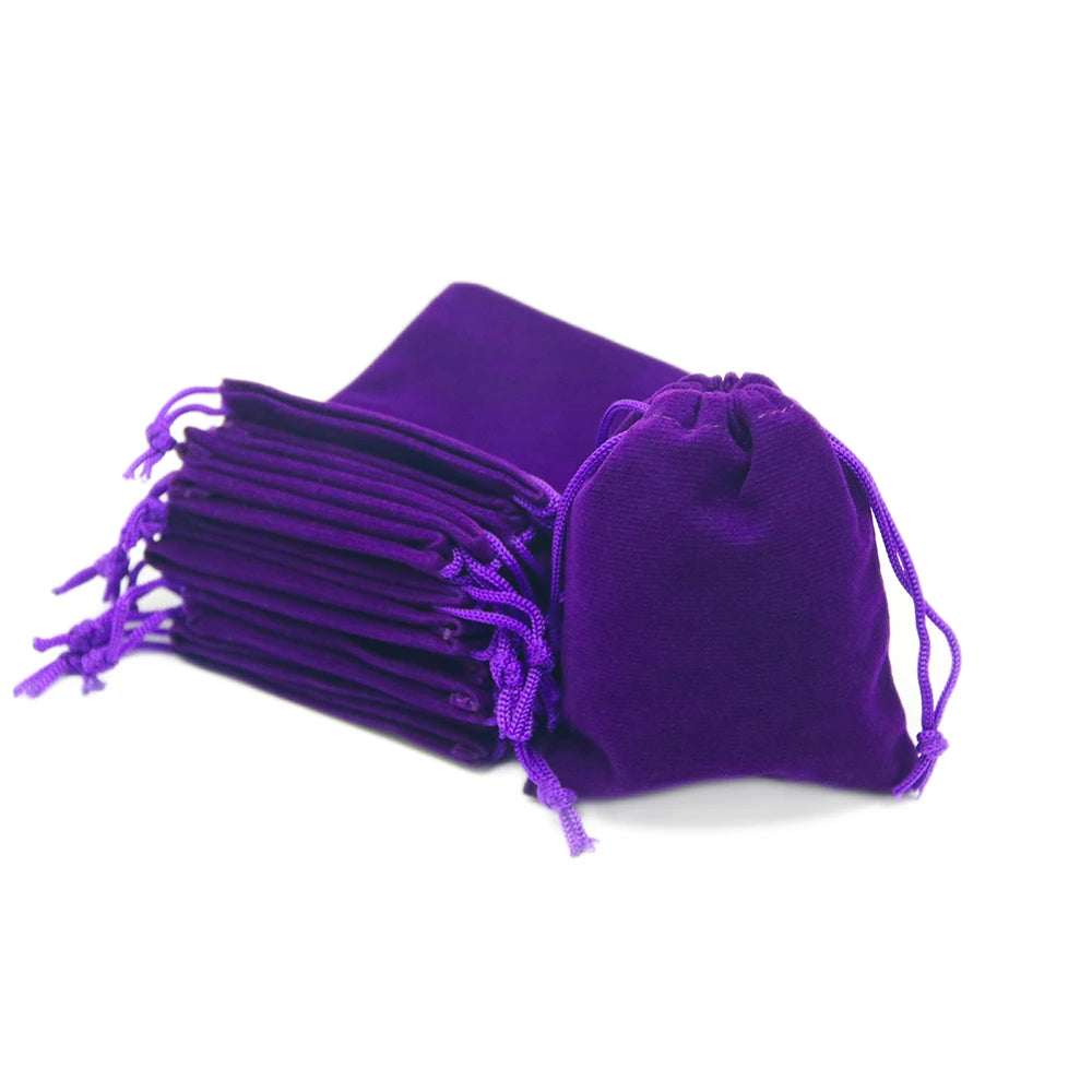 A purple compact drawstring dice bag with multiple strings visible.