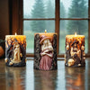 Three candles featuring silicone molds of witches and skulls in dark, textured glass.
