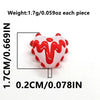A close-up view of red heart lampwork glass beads with white icing design, showing size and weight measurements.