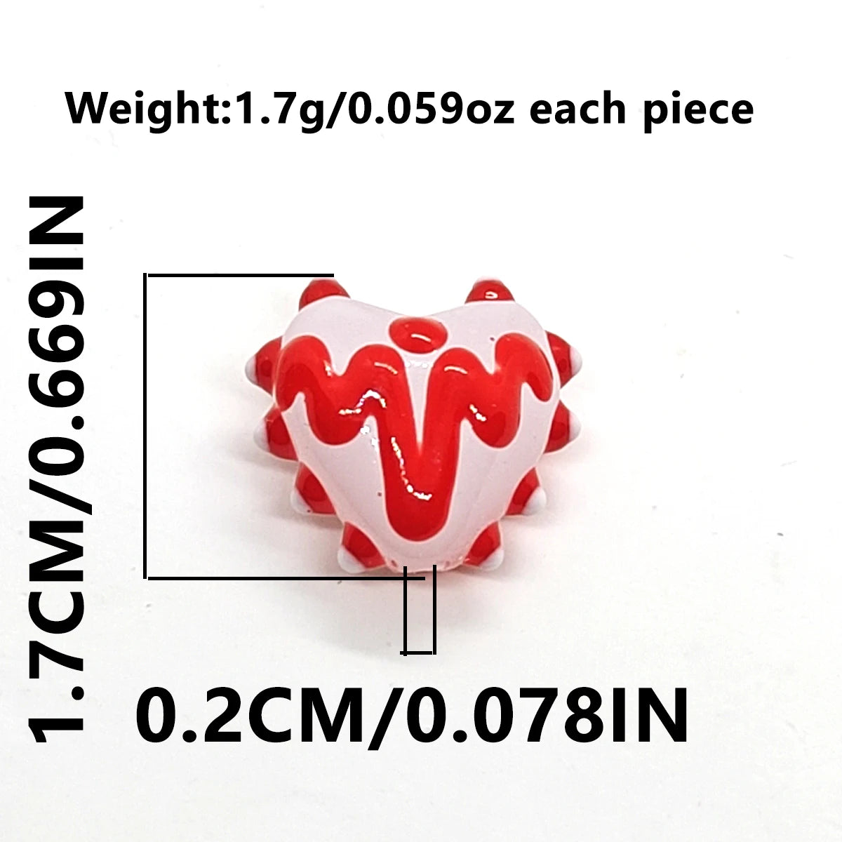 A close-up view of red heart lampwork glass beads with white icing design, showing size and weight measurements.
