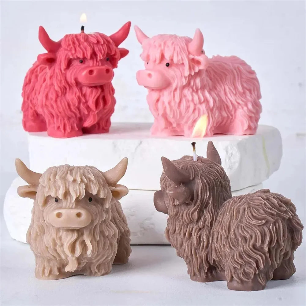 Three silicone molds of Highland cows in pink, red, and beige colors for candles, soap, and crafts.