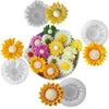 A collection of yellow, white, and pink silicone flower molds for candle making and soap crafting.